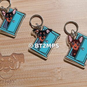 Min Pin Acrylic Keychain: Miniature Pinscher Peeking Behind Aqua Blue Door